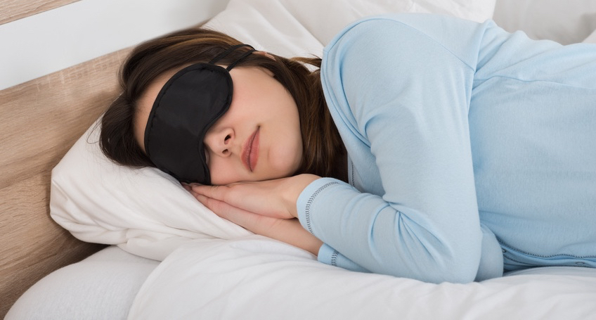 Woman Sleeping With Eyemask On Bed
